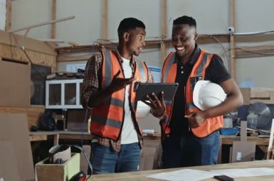 Young Male African factory workers inspecting a carpentry factory on digital tablet. High quality 4k footage